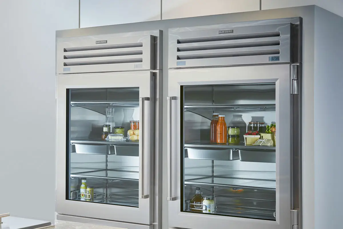 Two-door commercial glass-front freezer with food on the shelves