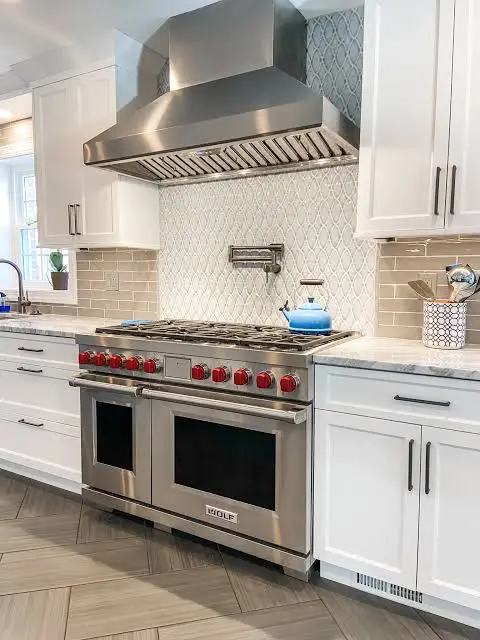 Wolf range repair in Beverly Hills, 48-inch Wolf dual fuel range with hood in a white kitchen