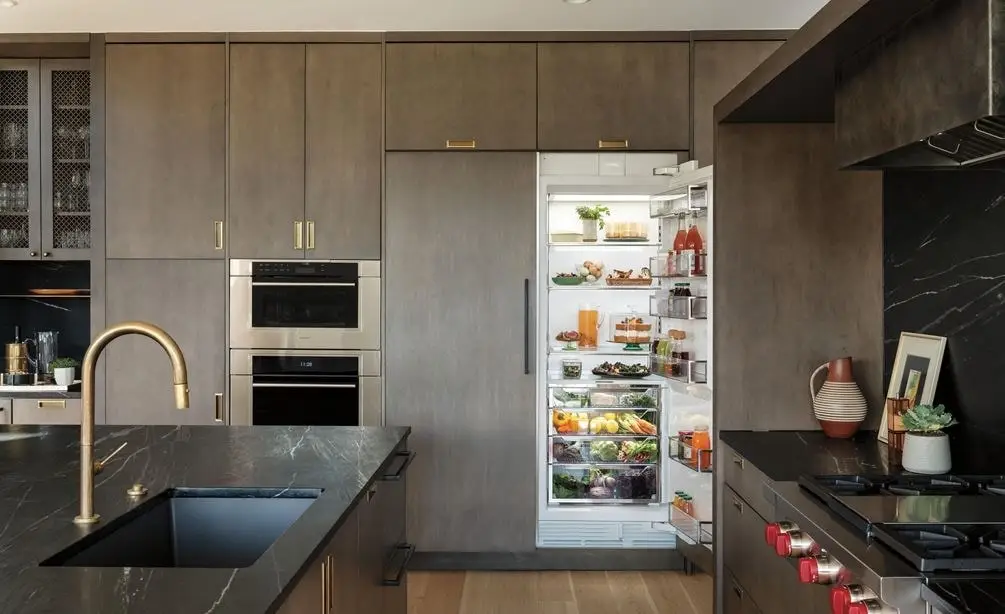 Sub-Zero repair in Calabasas, integrated Sub-Zero column refrigerator in a modern dark-wood kitchen
